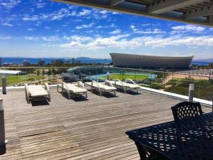 a deck with chairs and a view of a building at 145 on Main - Legacy Green Point in Cape Town