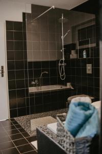 ein Badezimmer mit einer Dusche, einem Waschbecken und einer Badewanne in der Unterkunft Ferienwohnung Häserhof in Raddestorf