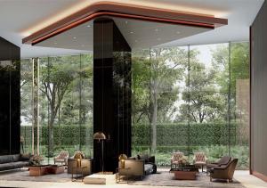 a lobby with couches and chairs and a large glass wall at The Panora Pattaya in Pattaya South
