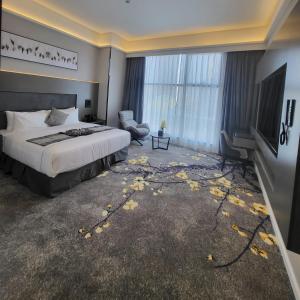 a hotel room with a bed and a television at Msharef almoden hotel فندق مشارف المدن in Riyadh