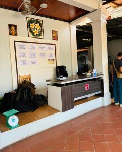 an office with a reception desk with a whiteboard at Singrarat Hotel in Luang Prabang