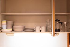 un estante con platos y tazas y platos. en Minato-ku - House - Vacation STAY 14528, en Tokio