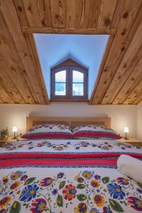 a bedroom with a large bed with a large window at Koliba pod Vlkolíncom in Ružomberok