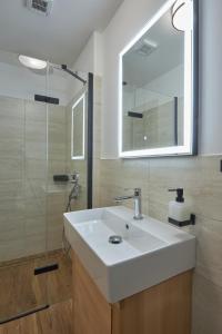 a bathroom with a white sink and a mirror at Koliba pod Vlkolíncom in Ružomberok