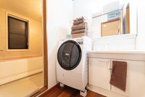 a washing machine in a bathroom with a window at Minato-ku - House - Vacation STAY 14528 in Tokyo