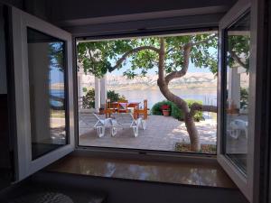 a view of a patio from the window of a house at Apartment Ante K A1 in Metajna