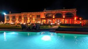 a large building with a pool in front of it at night at La Fairy Cappadocia in Uçhisar