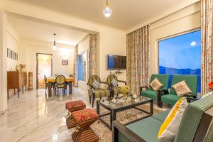 a living room with a couch and chairs and a table at Hostie Dale View North-3BHK, near Naldehra Golf course in Mashobra