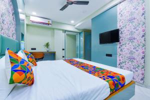 a bedroom with a bed and a tv on a wall at FabHotel Subh Hari in Jaipur