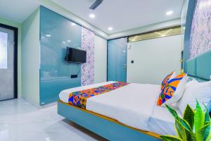 a bedroom with a bed and a tv in it at FabHotel Subh Hari in Jaipur