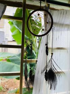 a dream catcher hanging on a wall at Ken House 1993 in Plei Kêp