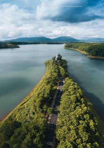 an island in the middle of a body of water at Ken House 1993 in Plei Kêp