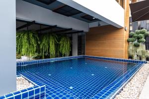 a swimming pool in the middle of a house at Beforesunset in Ban Chang Kham Luang