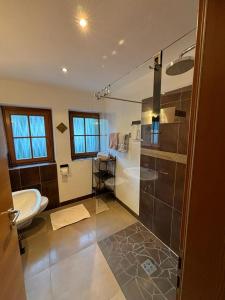 a bathroom with a shower and a toilet and a sink at Residence Zirmer in Kastelruth