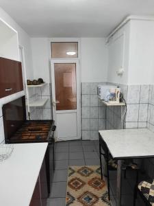 a small kitchen with a stove and a table at Apartament Del Dodo in Alba Iulia