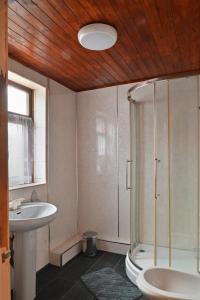 a bathroom with a shower and a toilet and a sink at Amarillys Guest House in Preston