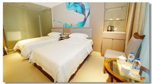 Llit o llits en una habitació de pristinehotel阳光商务酒店