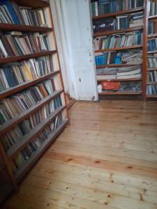 a room with two shelves filled with books at Levani's GuestHouse in Zugdidi