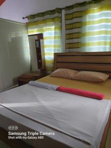 a bedroom with a bed with a red towel on it at Sur la route des tortues in Rodrigues Island