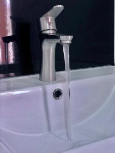 a faucet on top of a white sink at Mirissa Beach Inn in Mirissa