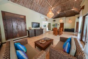 a living room with a couch and a table at Villa CHANDI 2 - Legian - Seminyak - 5 Bedroom 4 Bathroom Villa - Great Location ! in Seminyak