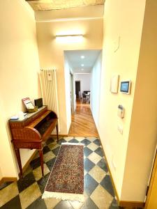 a hallway with a piano in a room at Via Umbria 25 Luxury Suites in Rome