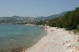 a beach with a group of people in the water at Apartman Nena in Klenovica +13 photos