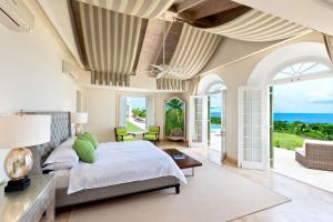 a bedroom with a bed and a view of the ocean at Marsh Mellow by Blue Sky Luxury in Saint James