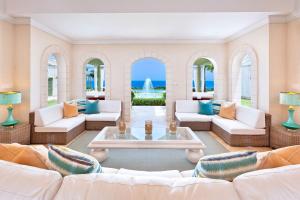 a living room with white furniture and the ocean at Marsh Mellow by Blue Sky Luxury in Saint James +12 photos