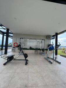 a room with a gym with two exercise bikes at Wawa Guesthouse Pollux Habibie Batam Tower A 17 in Kangboi