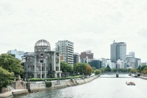 a river with a city in the background at Hostel Mange Tak in Hiroshima