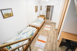 a room with two beds and a mirror at Ruse Apartment Center in Ruse