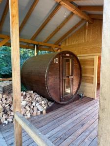 a large wooden barrel sitting on top of a deck at Wapienne domek in Sękowa