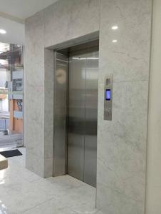 a elevator in a building with a sign on it at St. Marvin Studio Makati M409 in Manila