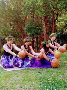a group of women in dresses holding pumpkins at Camp NATURE in Bli Bli
