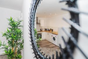 a view of a kitchen from a mirror at VICHY - The Thornhill City Center Apartment in Wakefield