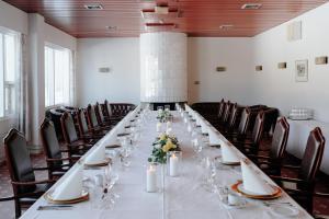 a long table in a room with chairs at Hotel Waltikka in Valkeakoski