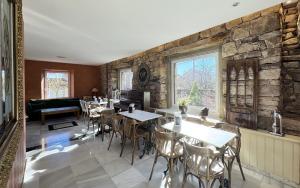 una sala da pranzo con tavoli e un muro in pietra di Posada Villa Rosa a Reinosa