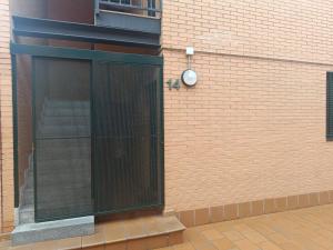 a glass door on the side of a brick building at El bosque - CON PARKING GRATIS in Toledo