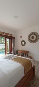 a bedroom with two beds and a large window at The Breeze Stay and Surf Canggu Bali in Canggu