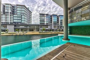 a swimming pool in front of some apartment buildings at Luxury 1 Bedroom apartment in Canal Quays in Cape Town