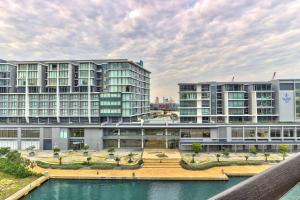 an image of an apartment complex with a body of water at Luxury 1 Bedroom apartment in Canal Quays in Cape Town