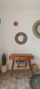 a wooden table with a mirror on the wall at The Breeze Stay and Surf Canggu Bali in Canggu