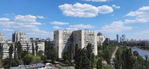a view of a city with tall white buildings at Велика 1к квартира біля метро Лівобережна вулиця Флоренції 1 in Kyiv