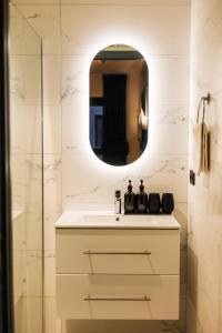 een badkamer met een wastafel en een spiegel bij YUP Hotel in Hasselt
