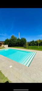a large swimming pool with blue water at San Michele Apartments&Rooms in Catanzaro