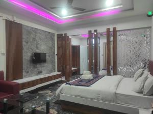 a bedroom with a bed and a tv in a room at HOTEL SG HUB TOWER in Margherita