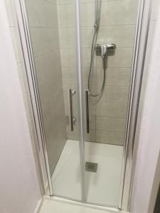 a shower with a glass door in a bathroom at La Mansio de Bons in Les Deux Alpes