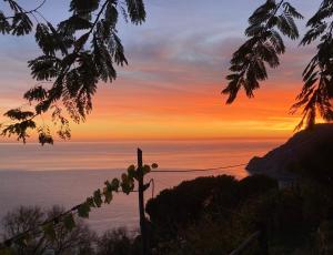 a sunset view of the ocean from a hill at Villa Pietrafiore in Monterosso al Mare
