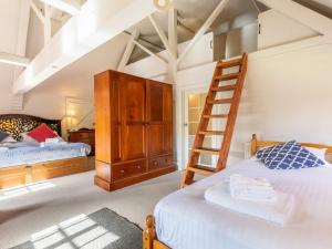 a bedroom with two beds and a ladder at 1 bed in Beaulieu 53042 in Beaulieu